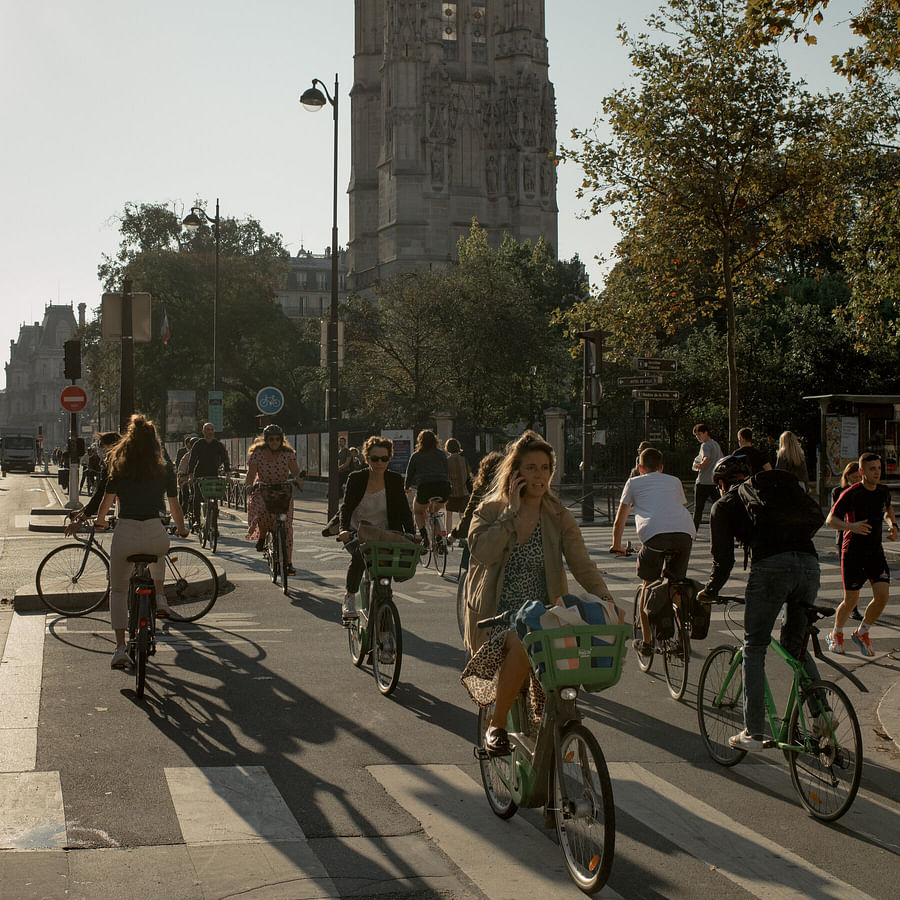 Busy European city street filled with cyclists and pedestrians