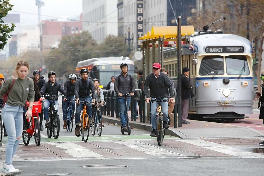 Busy street in San Francisco filled with pedestrians and cyclists